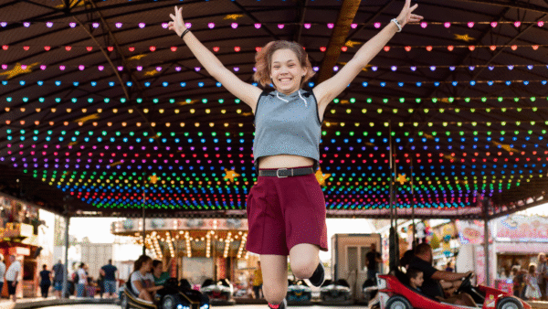 A Student Jumping In a Prom Fundraising Outdoor Carnival